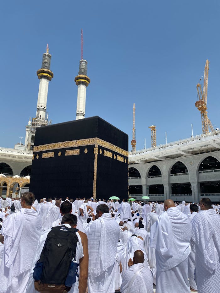 zipwp-image-18996761 People in Ahram Clothing on Pilgrimage Praying by Kaaba in the Courtyard of the Great Mosque of Mecca